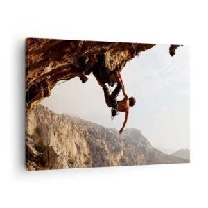 Canvastavla - Bild på duk - En klättrare på en brant klippa i bergen i solskenet - 70x50cm - Världen i näven - Modern väggdekoration för vardagsrum och sovrum ARTTOR