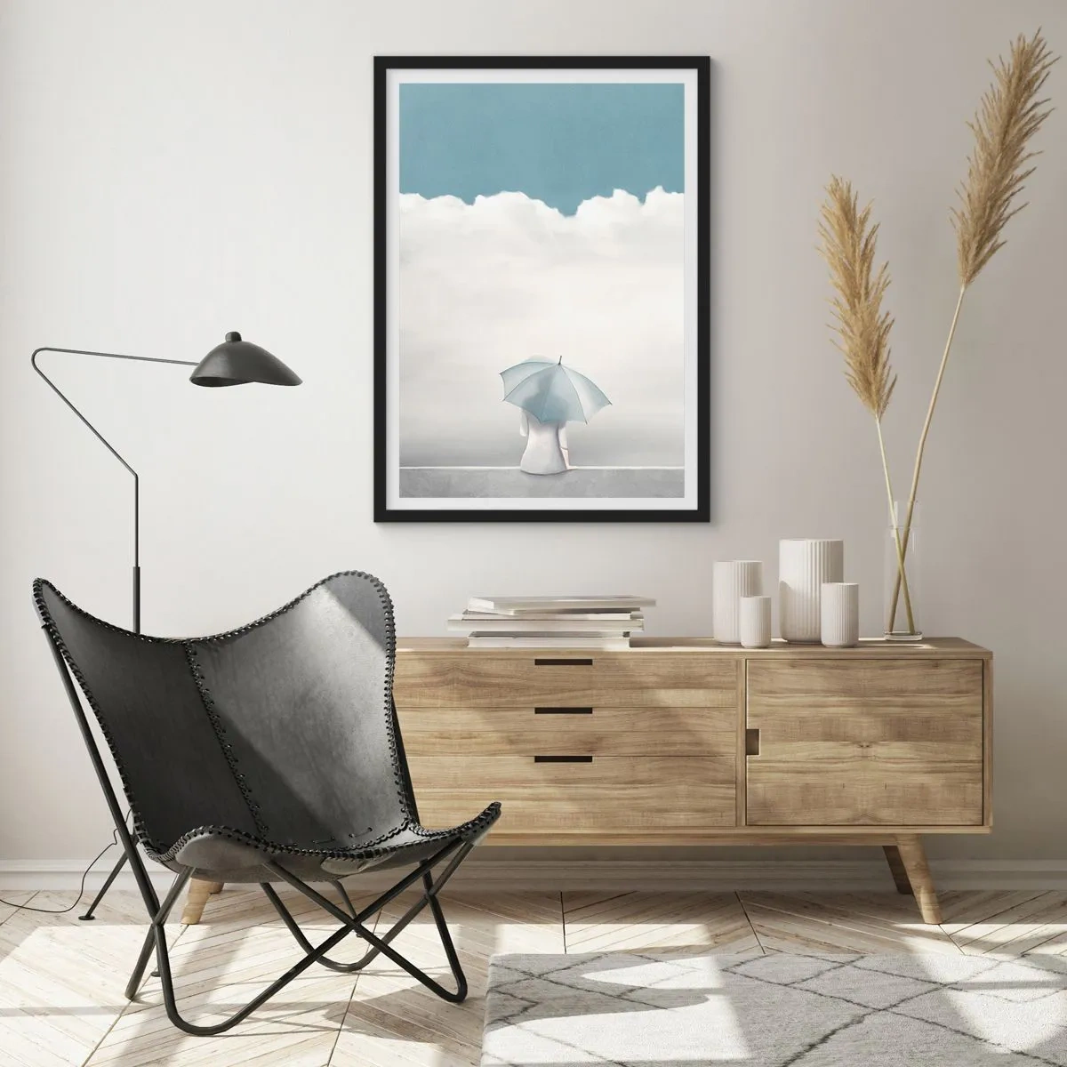 Affisch i svart ram - En figur med ett paraply som sitter på en avsats bland molnen - 50x70cm - På gränsen mellan java och dröm - Modern väggdekoration för vardagsrum och sovrum ARTTOR