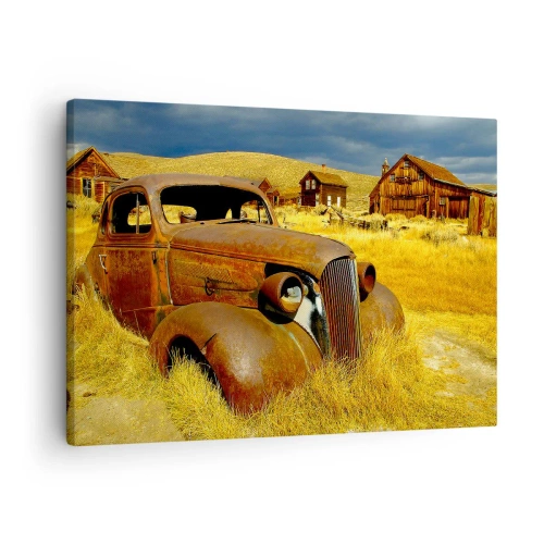 Canvastavla - Bild på duk - En gammal rostig bil mot bakgrund av övergivna trähyddor - 70x50cm - Välförtjänt vila - Modern väggdekoration för vardagsrum och sovrum ARTTOR