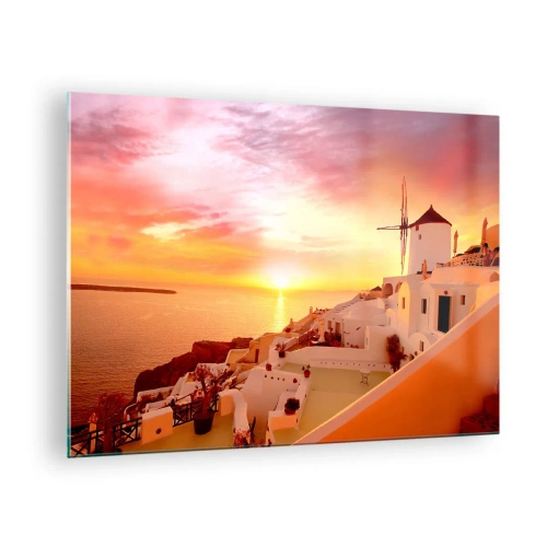 Glastavla - Bild på glas - Solnedgång över Santorini med vita byggnader och en väderkvarn - 70x50cm - Smälta sig in i vitt och guld - Modern väggdekoration för vardagsrum och sovrum ARTTOR