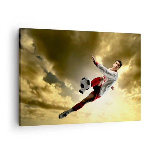 Canvastavla - Bild på duk - En fotbollsspelare i ett dynamiskt hopp som sparkar bollen mot himlen - 70x50cm - Fotbollshimmel - Modern väggdekoration för vardagsrum och sovrum ARTTOR