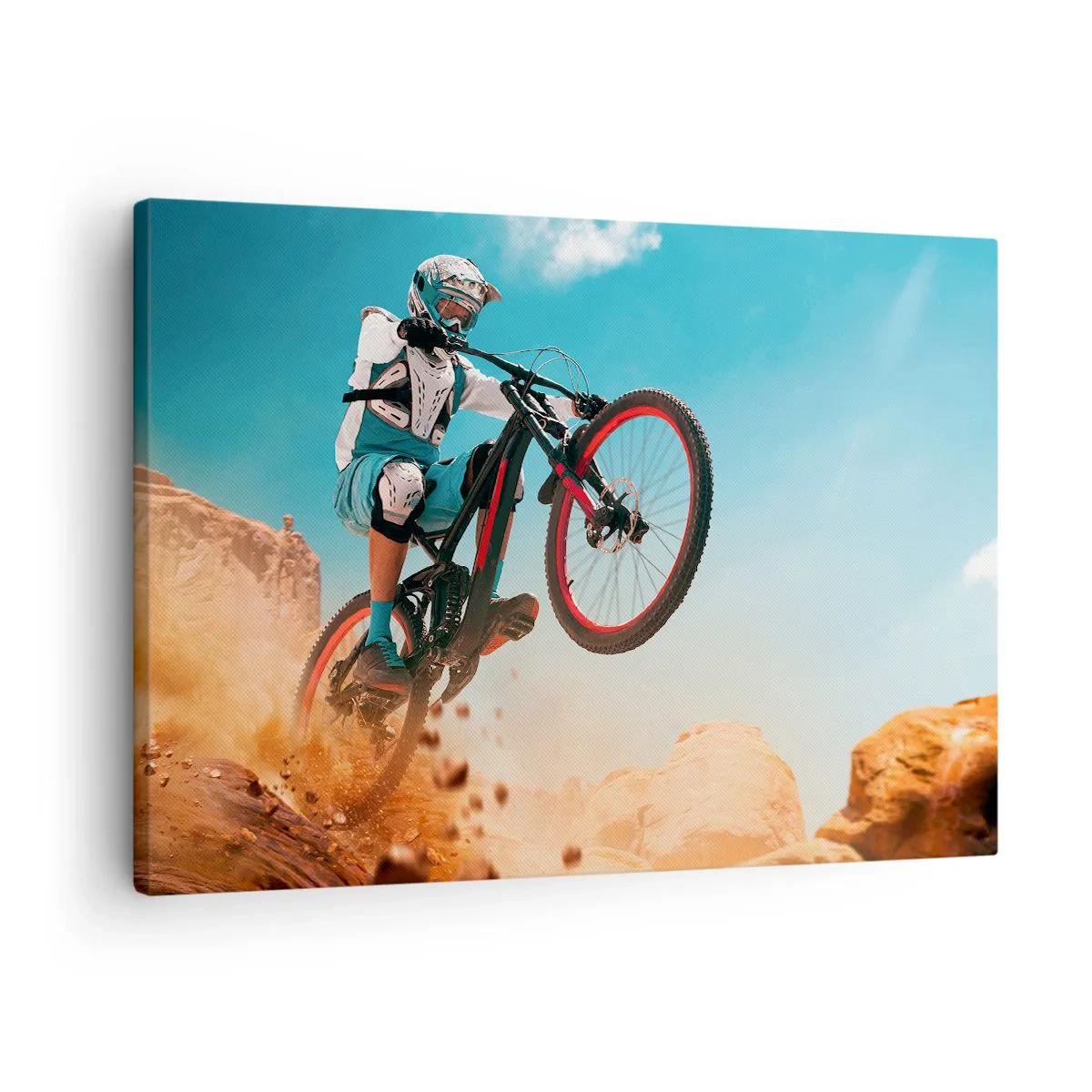 Canvastavla - Bild på duk - En mountainbiker utför ett hopp mot en bakgrund av stenar - 70x50cm - Cykelgalning - Modern väggdekoration för vardagsrum och sovrum ARTTOR