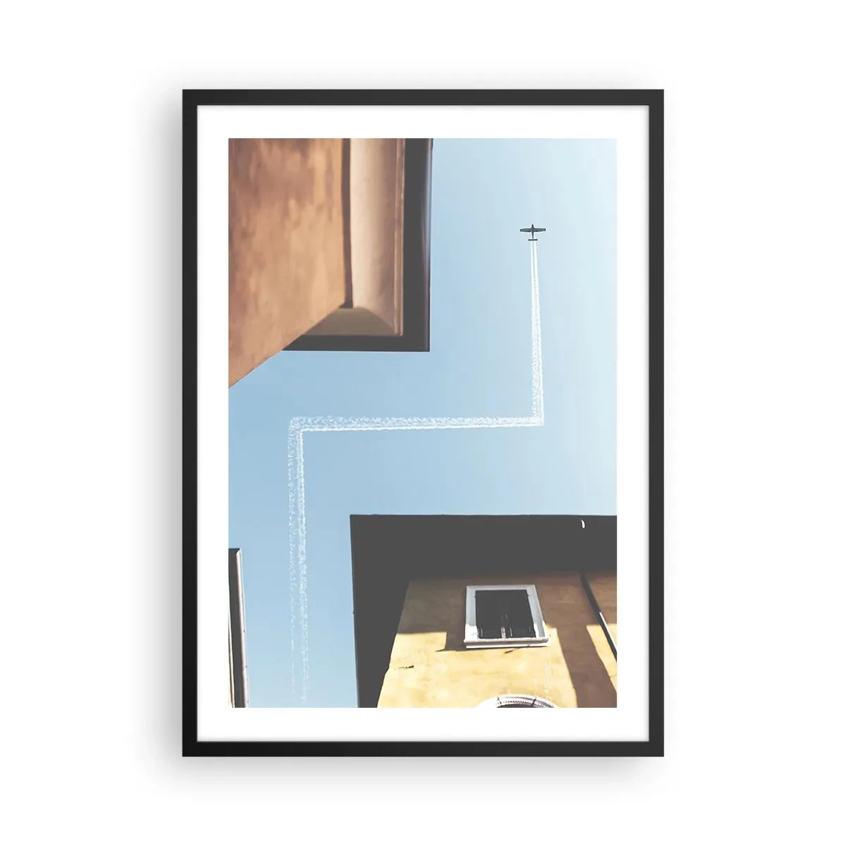 Affisch i svart ram - Perspektiv av byggnader med ett flygplan och en ovanlig bana på himlen - 50x70cm - Ovanför stadens labyrint - Modern väggdekoration för vardagsrum och sovrum ARTTOR