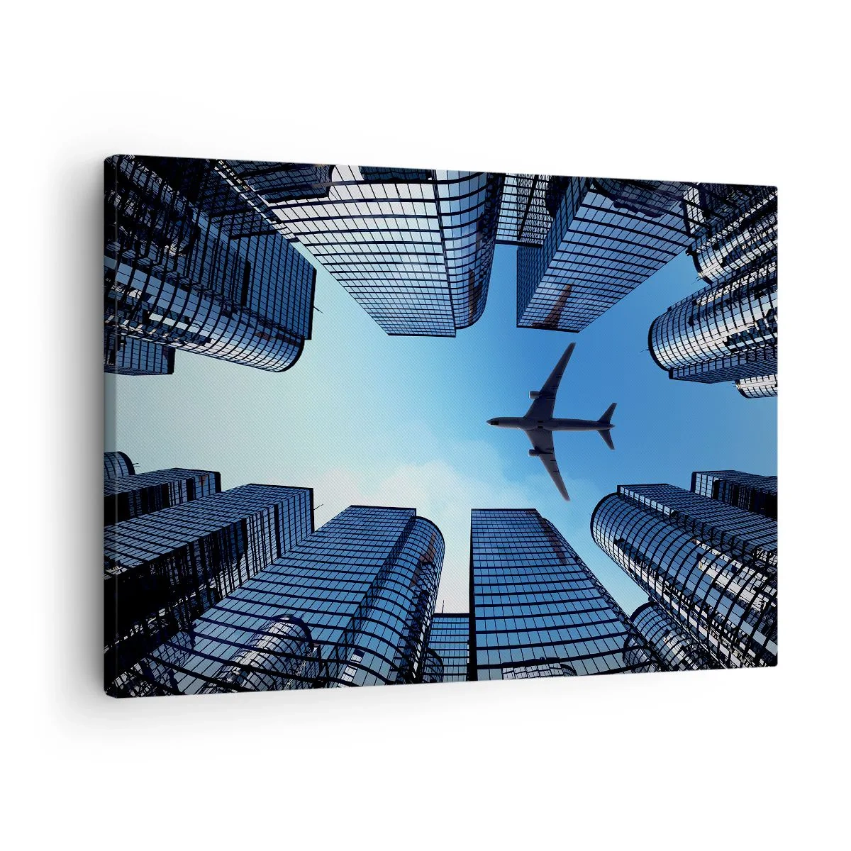 Canvastavla - Bild på duk - Ett flygplan som flyger över moderna skyskrapor i stadens centrum. - 70x50cm - Utsikten från glasravinen - Modern väggdekoration för vardagsrum och sovrum ARTTOR